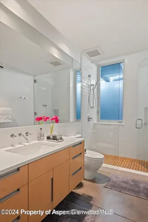 a living room with furniture a flat screen tv and a table