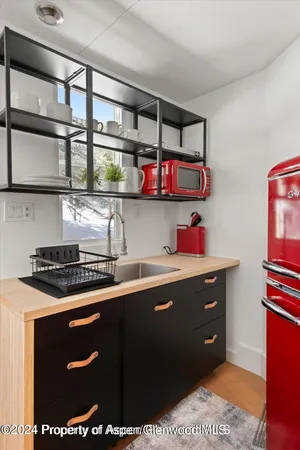 a view of a sink and cabinets in a room