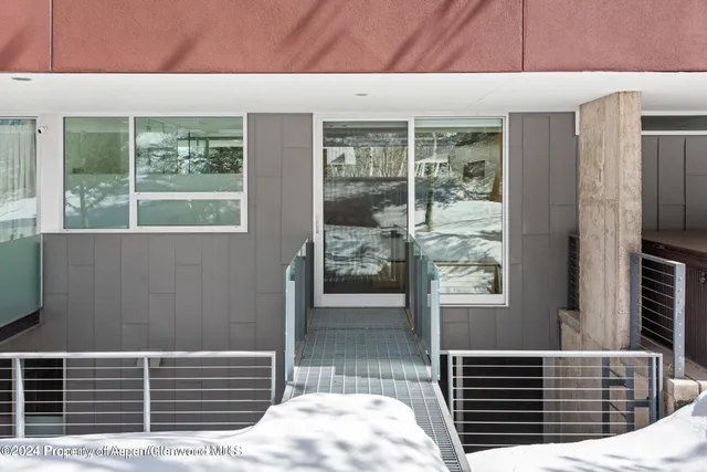 a view of a patio with table and chairs potted plants and large tree