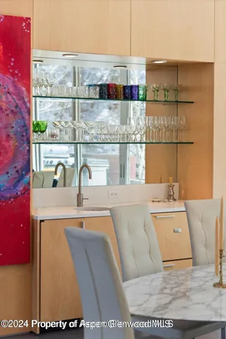 a kitchen with a sink and view of living room