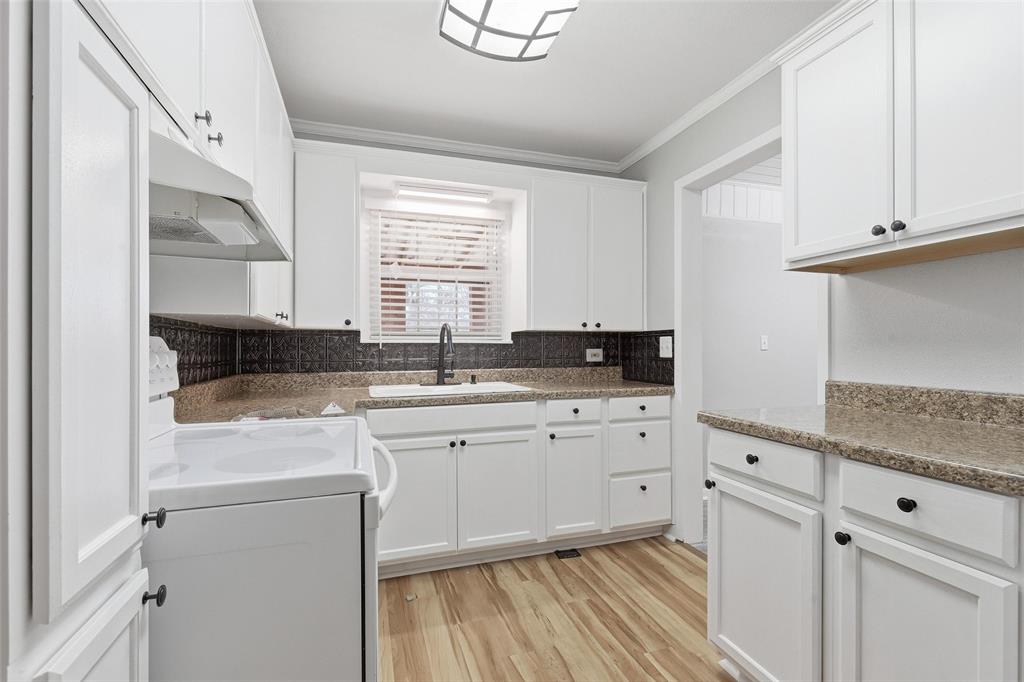 216 4th Street Joshua, TX 76058 - Photo 13 of 40 a kitchen with granite countertop white cabinets and white appliances