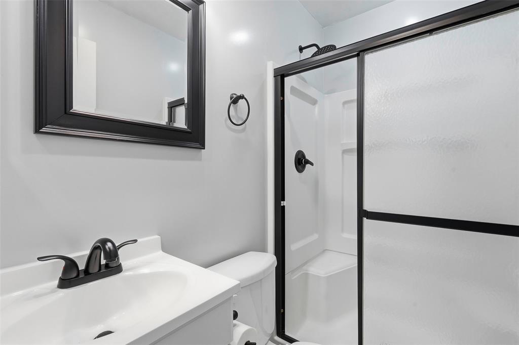 216 4th Street Joshua, TX 76058 - Photo 15 of 40 a bathroom with a sink and mirror
