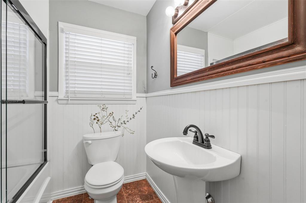 216 4th Street Joshua, TX 76058 - Photo 21 of 40 a bathroom with a toilet sink and mirror