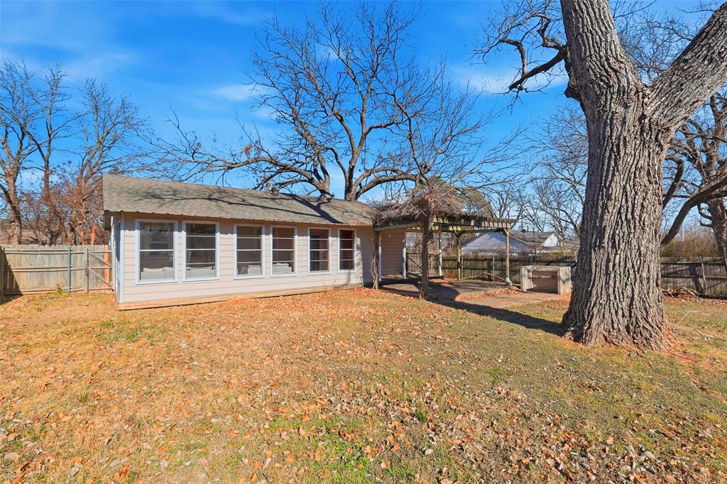 216 4th Street Joshua, TX 76058 - Photo 26 of 40 a view of a house with a tree in the background