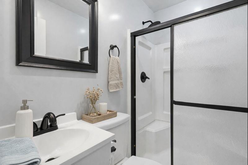 216 4th Street Joshua, TX 76058 - Photo 7 of 40 a bathroom with a sink and mirror