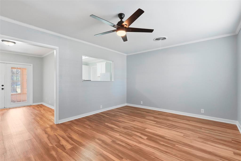 216 4th Street Joshua, TX 76058 - Photo 8 of 40 an empty room with wooden floor and ceiling fan