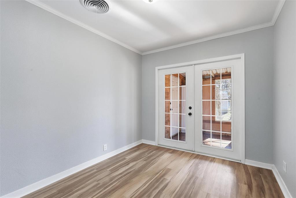 216 4th Street Joshua, TX 76058 - Photo 10 of 40 an empty room with wooden floor and windows