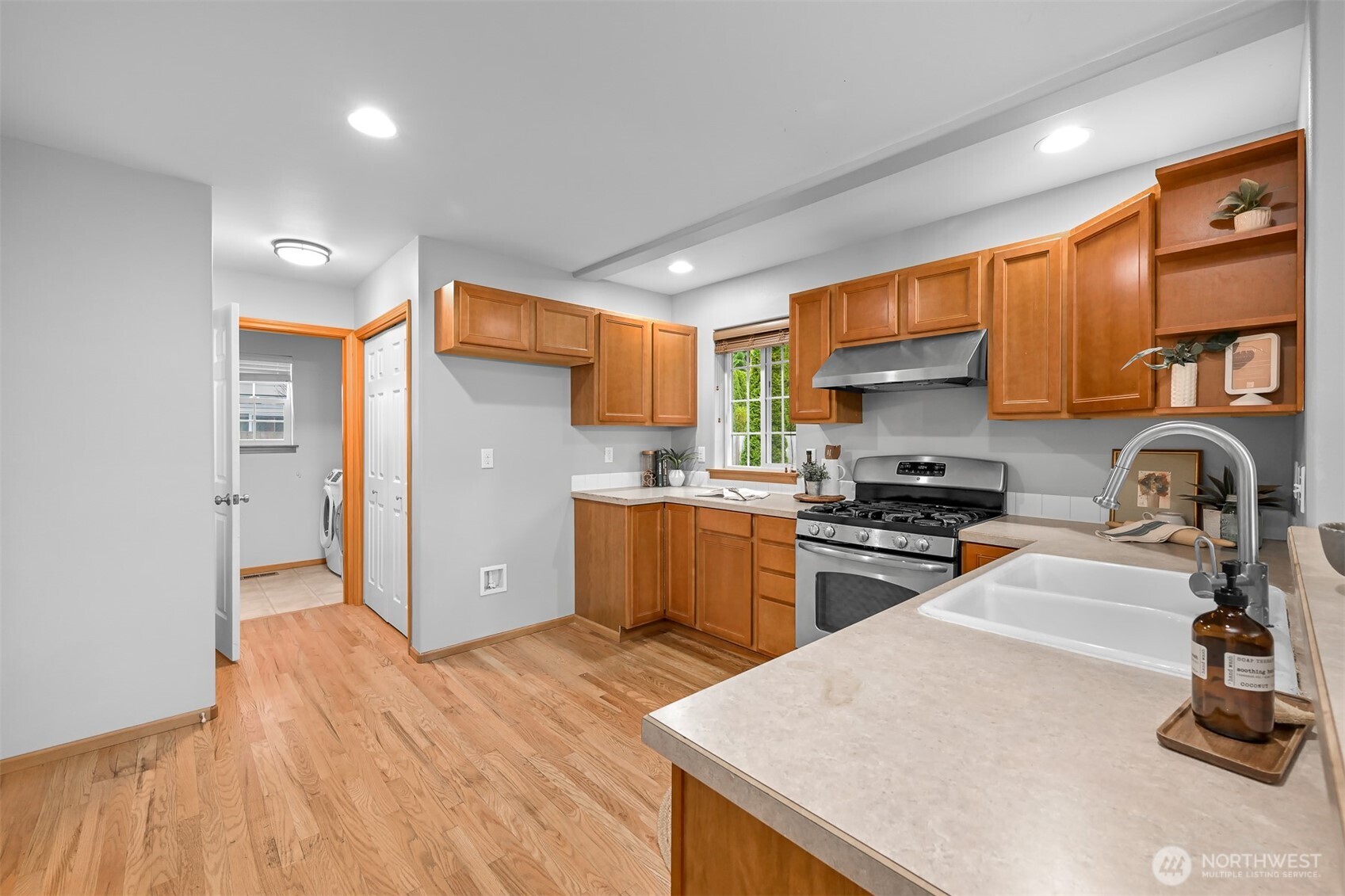 3500 South Avenue Bellingham, WA 98229 - Photo 12 of 38 a kitchen with stainless steel appliances kitchen island granite countertop a refrigerator and a stove top oven