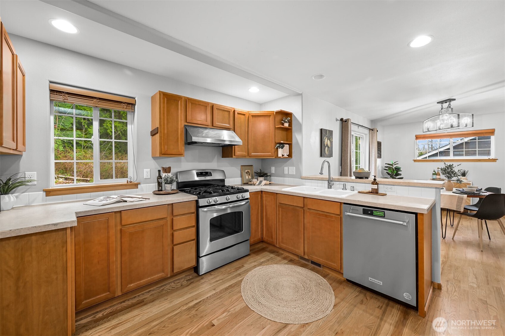 3500 South Avenue Bellingham, WA 98229 - Photo 13 of 38 a kitchen with stainless steel appliances granite countertop a stove a sink dishwasher and a microwave oven with white cabinets