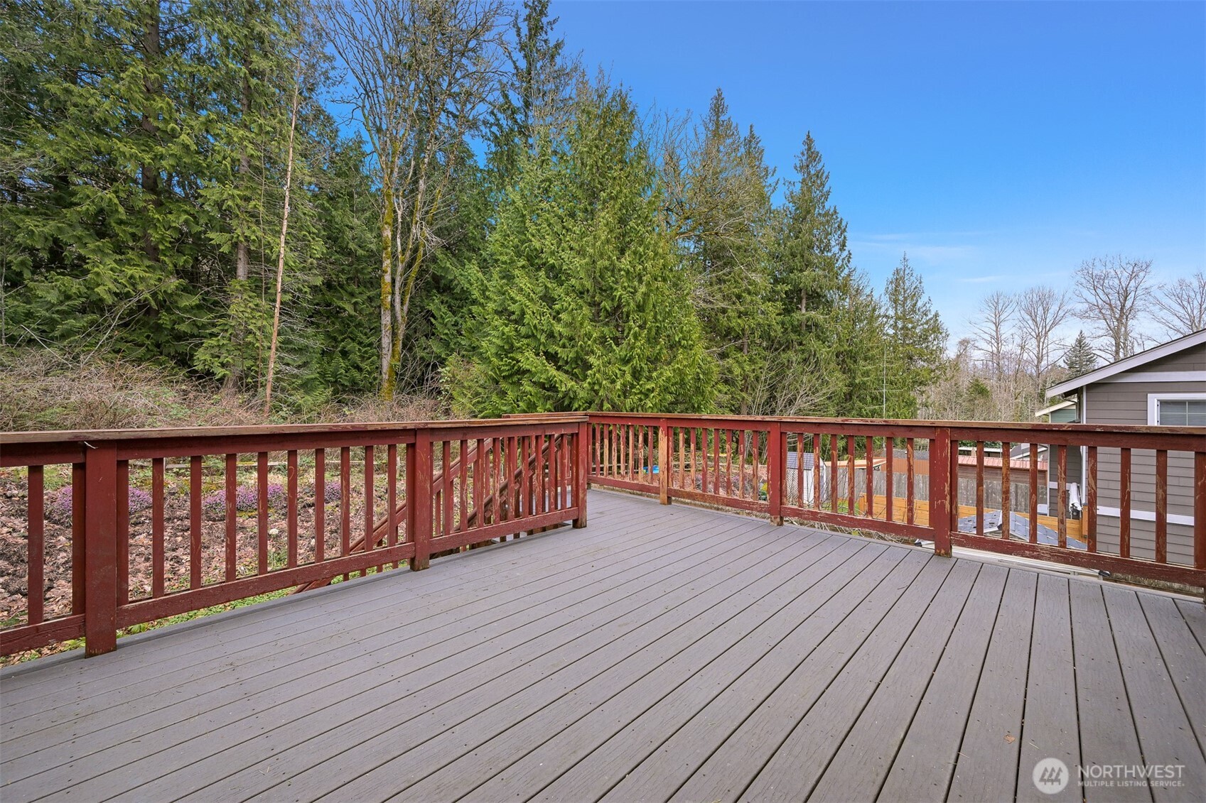 3500 South Avenue Bellingham, WA 98229 - Photo 34 of 38 a balcony with wooden floor and trees in the background