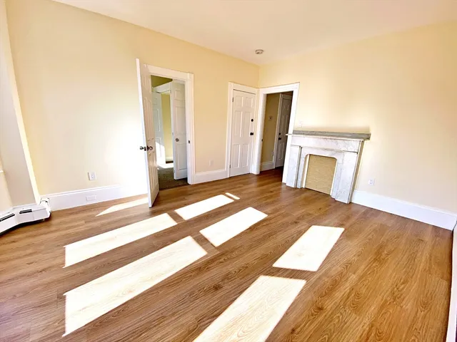 a view of a bedroom with wooden floor and bedroom