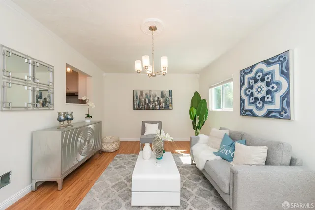 a living room with furniture and a chandelier
