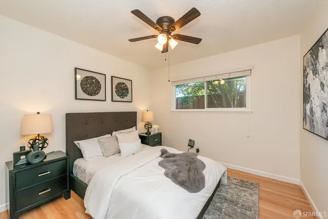 a bedroom with a large bed and a window