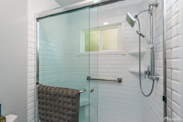 a bathroom with a toilet a sink a vanity and mirror