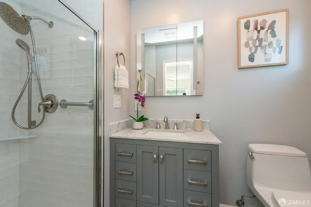 a view of a backyard with potted plants and wooden fence