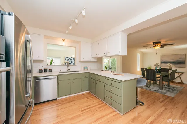 a kitchen with a sink window and cabinets
