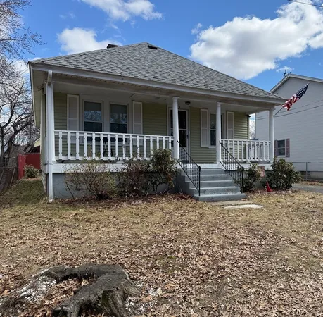 a view of a house with a small yard and wooden floor and fence