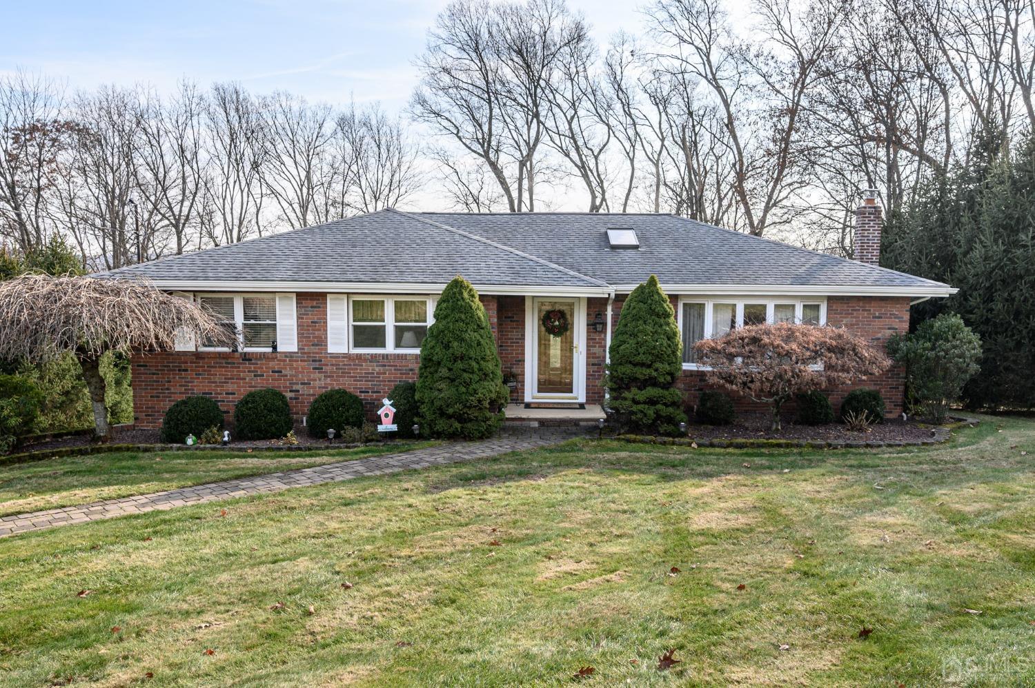 7 Putters Road Succasunna, NJ 07876 - Photo 1 of 40 a front view of a house with a garden and trees