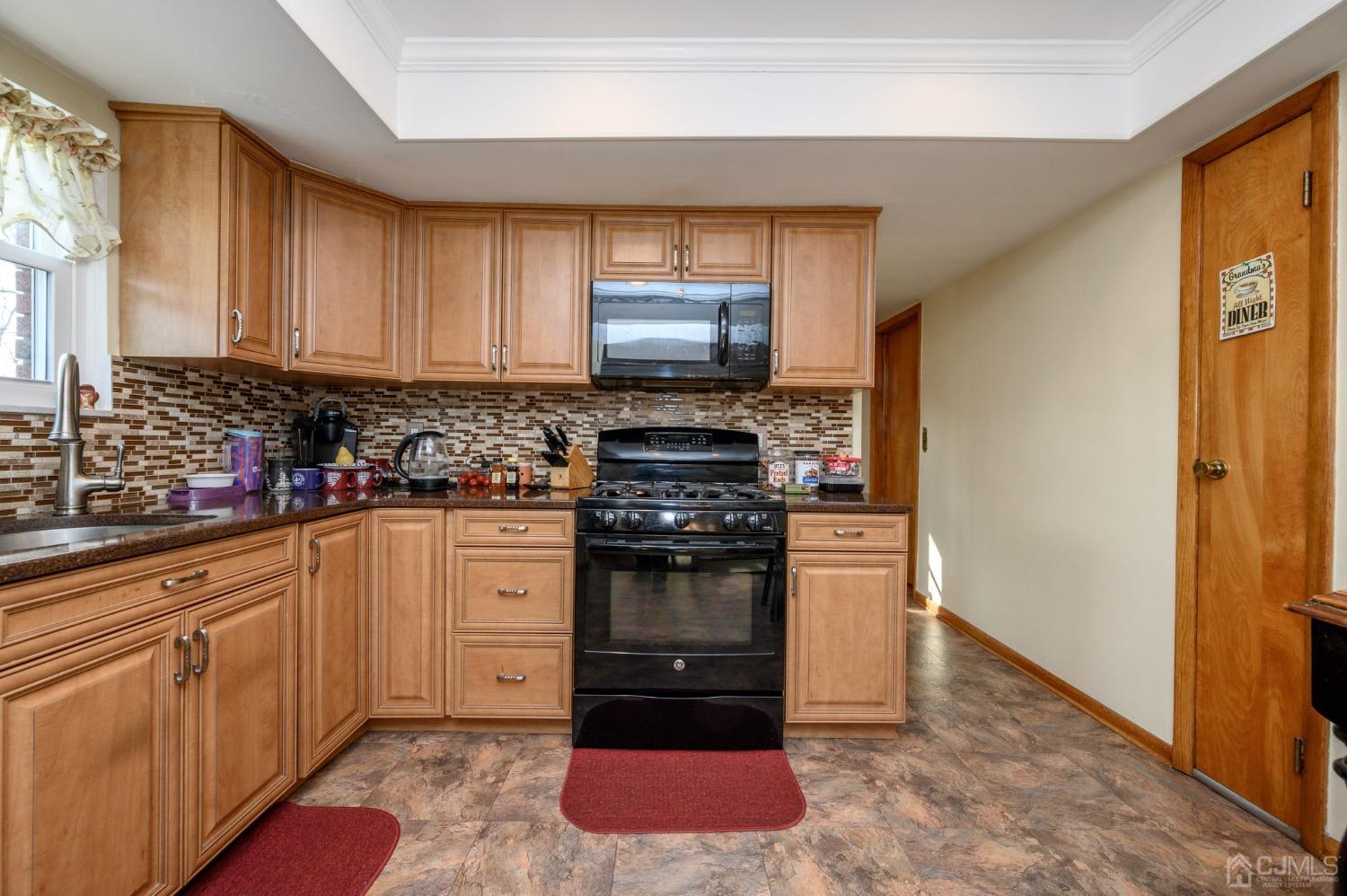 7 Putters Road Succasunna, NJ 07876 - Photo 12 of 40 a kitchen with stainless steel appliances granite countertop a stove a sink and a refrigerator