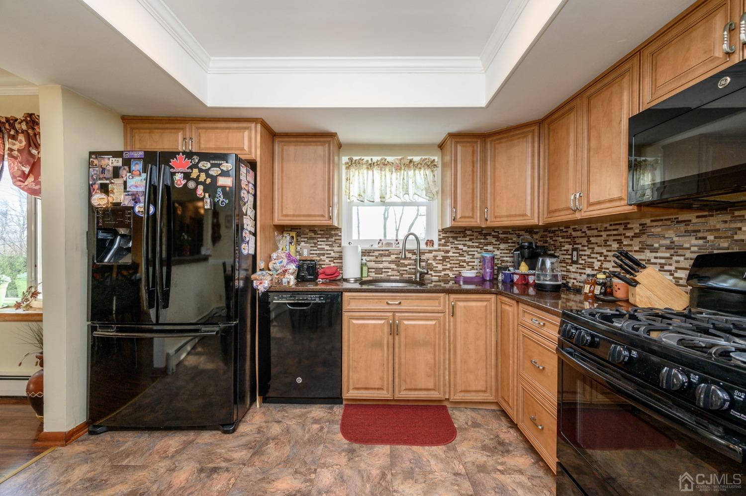 7 Putters Road Succasunna, NJ 07876 - Photo 13 of 40 a kitchen with a refrigerator stove and wooden cabinets
