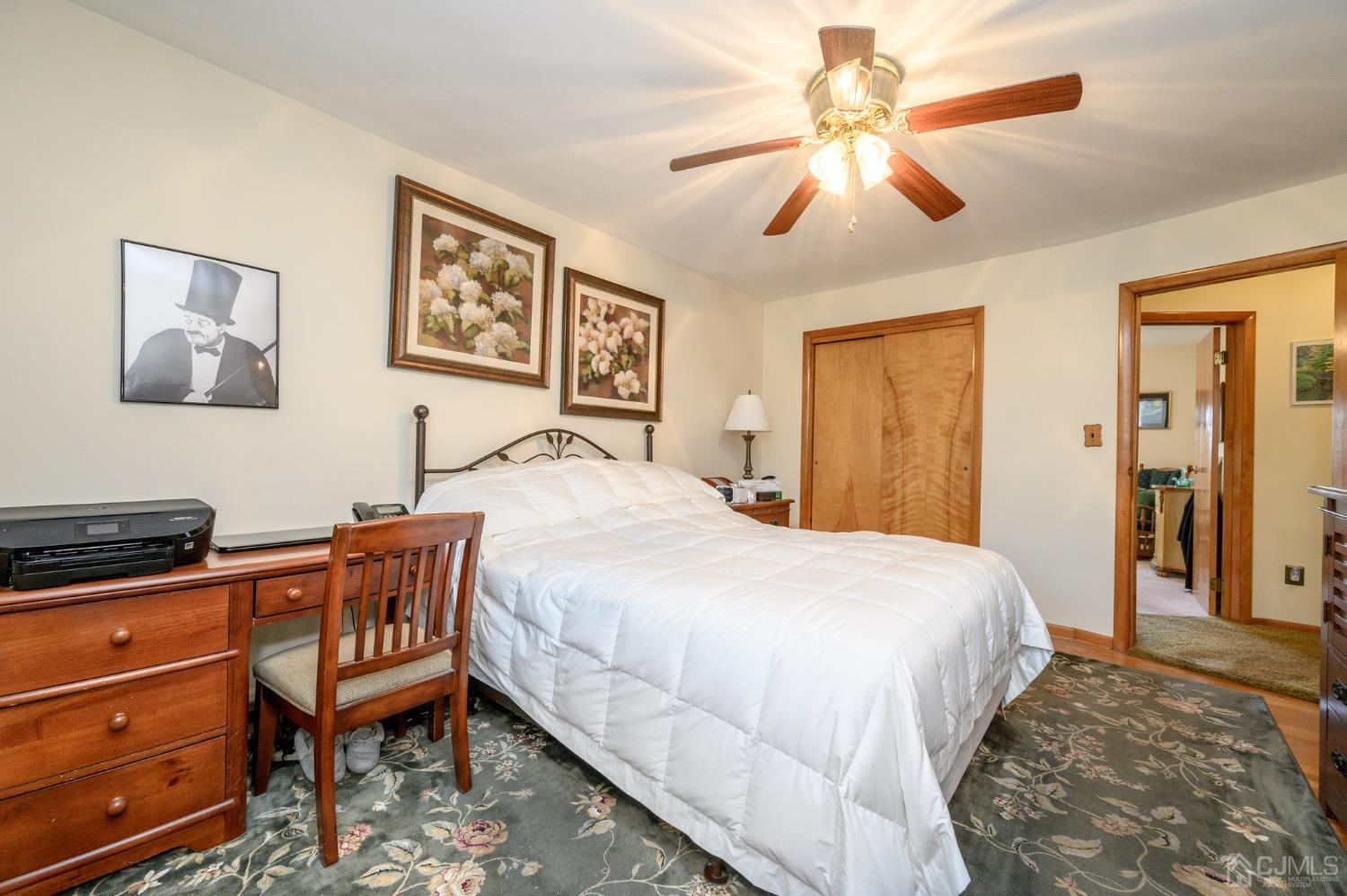 7 Putters Road Succasunna, NJ 07876 - Photo 23 of 40 a bedroom with a bed and a chandelier