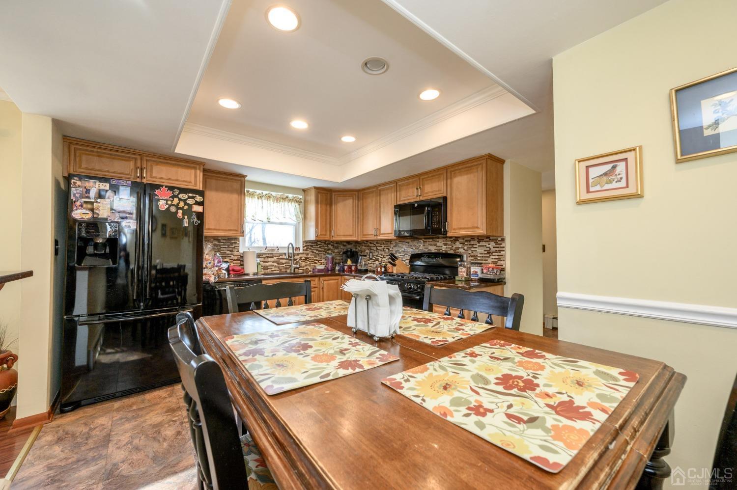 7 Putters Road Succasunna, NJ 07876 - Photo 10 of 40 a kitchen with stainless steel appliances kitchen island granite countertop a refrigerator and stove top oven