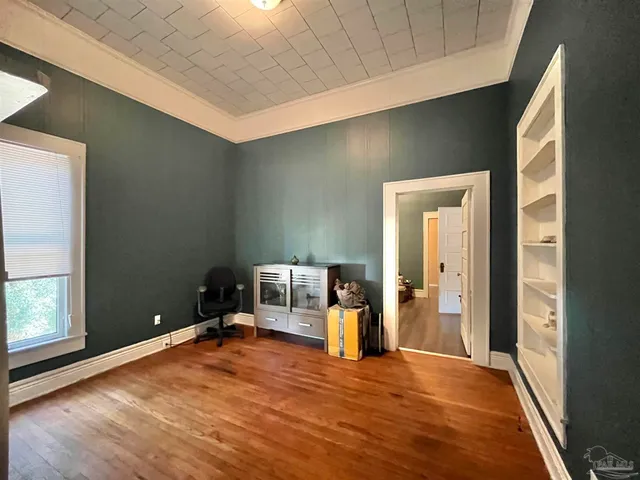 a view of empty room with wooden floor