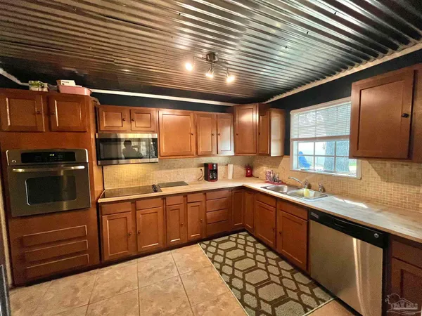 a kitchen with stainless steel appliances granite countertop sink stove and cabinets