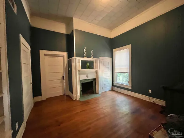 a view of a livingroom with an empty space and a fireplace