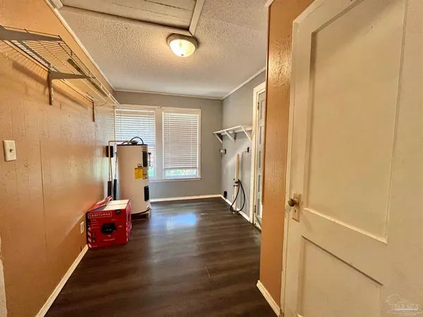a view of a room with wooden floor and furniture