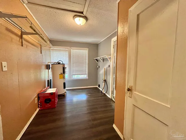 a view of a room with wooden floor and furniture