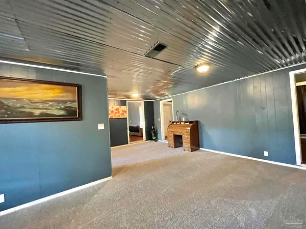 a view of a livingroom with wooden floor and a ceiling fan