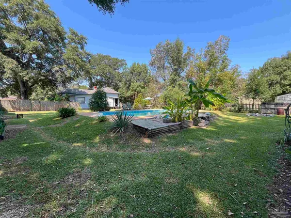 a view of a backyard with sitting area
