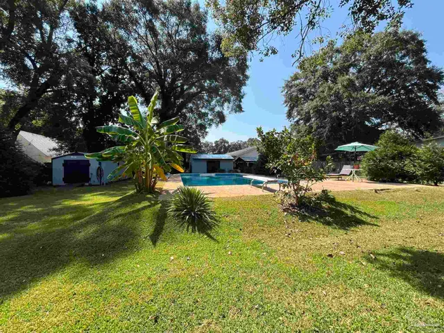 a view of a yard with swimming pool