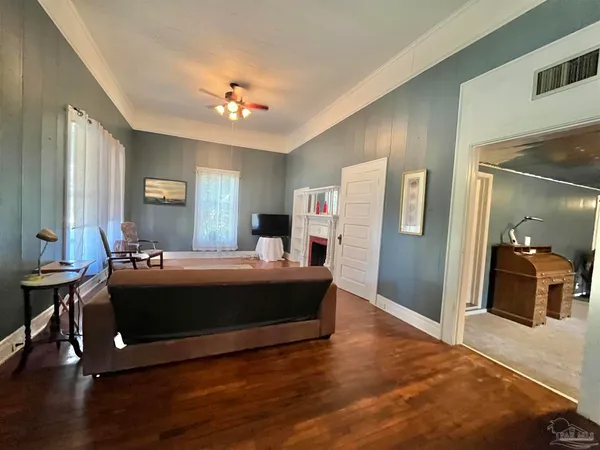 a spacious bedroom with a large bed and a chandelier