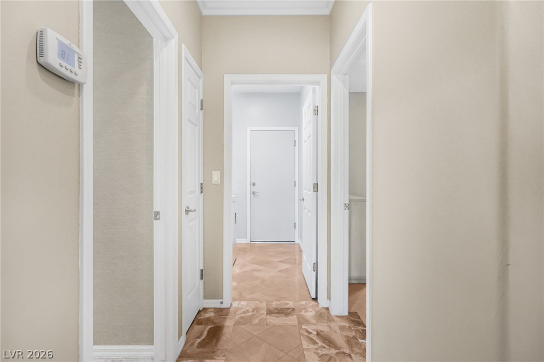 2738 Grand Forks Road Henderson, NV 89052 - Photo 26 of 52 Gleaming tile floors guide the way through a central hallway connecting multiple living spaces.