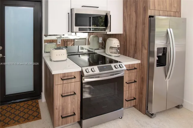 a kitchen with a sink stove and refrigerator