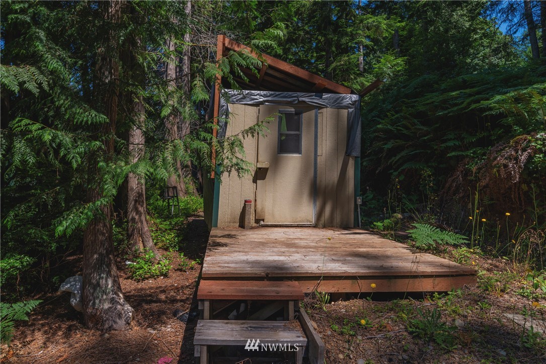 1192 Black Point Road Brinnon, WA 98320 - Photo 4 of 10 two wooden chairs sitting in a backyard