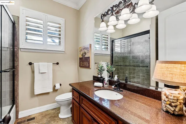 a view of walk in closet with clothes