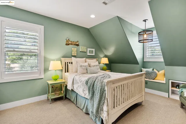 a spacious bedroom with a large bed and a flat screen tv