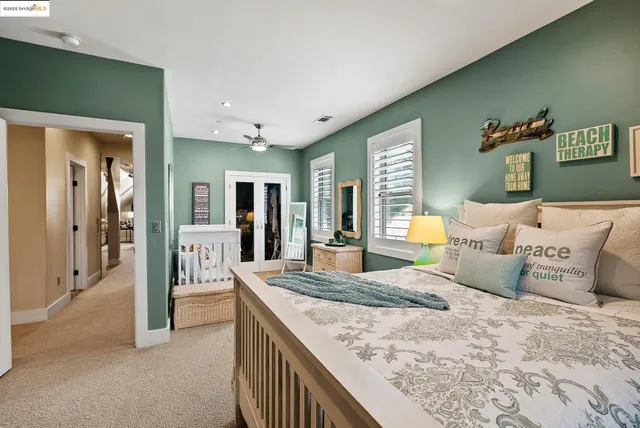 a bedroom with a large bed and a chandelier