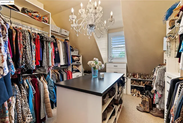 a large white kitchen with stainless steel appliances kitchen island granite countertop a sink and cabinets