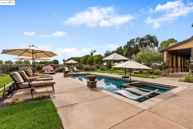 a living room with patio furniture and a flat screen tv