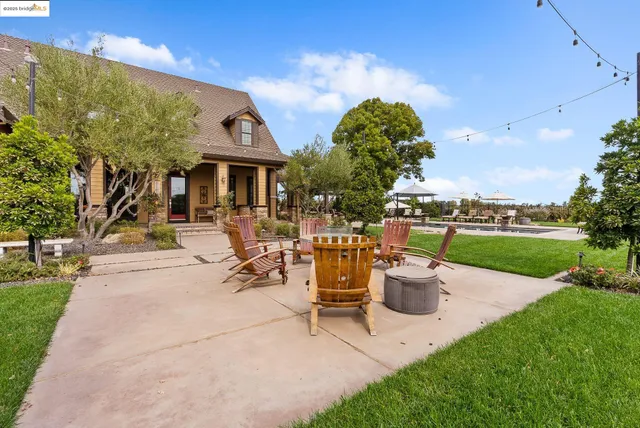 an aerial view of a house with a garden and trees