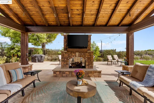 a dining room with wooden floor a chandelier a wooden table and chairs