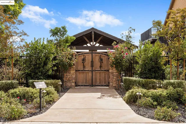 a view of a room with kitchen island stainless steel appliances wooden floor and living room view