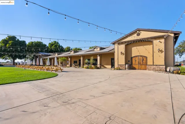 a kitchen with stainless steel appliances granite countertop lots of counter top space and wooden floor
