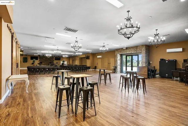 a kitchen with stainless steel appliances granite countertop a stove a sink and a wooden floors