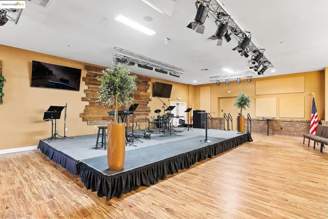 a view of kitchen center island wooden floor and living room
