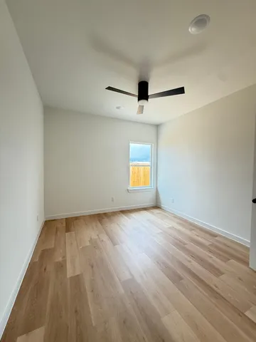 an empty room with a empty space and windows